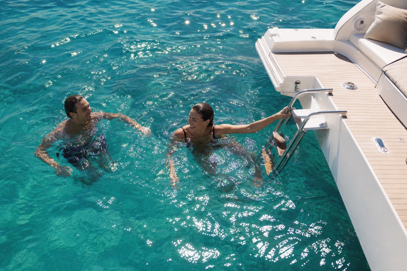 Turquoise water, swimmers off the bathing ladder